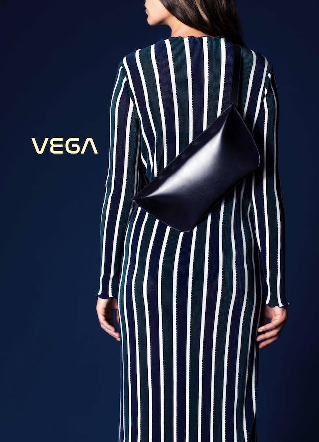 Rückenansicht einer Frau im gestreiften Kleid mit dem Taschenmodell VEGA